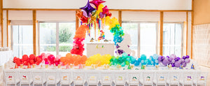 unicorn party set up with a themed children's table and balloons