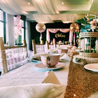 kids high tea party with balloons and a dessert table