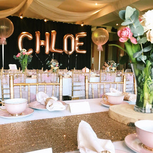 pink and gold kids high tea with themed balloons