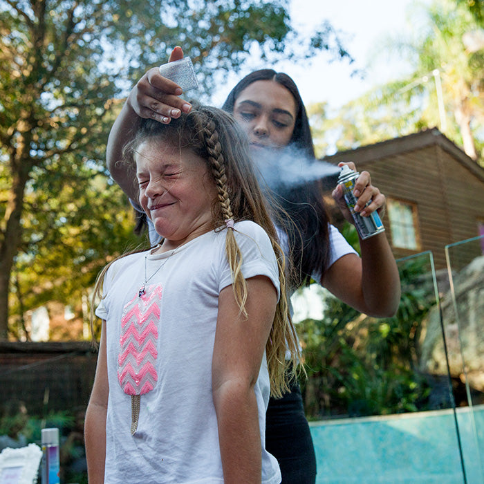 a party girl getting glam glitter hair spray