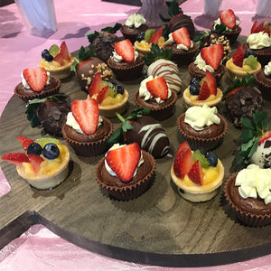 a dessert board catered for a child's birthday party with a selection of sweet food items